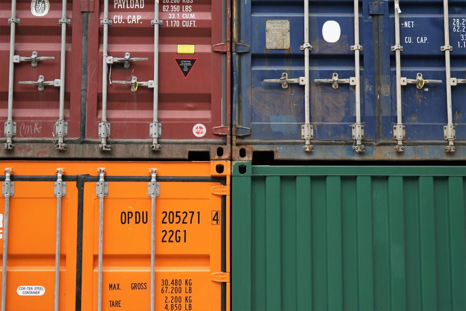 Stacked shipping containers representing WhatsApp chatbot ERP integration for GCC supply chains
