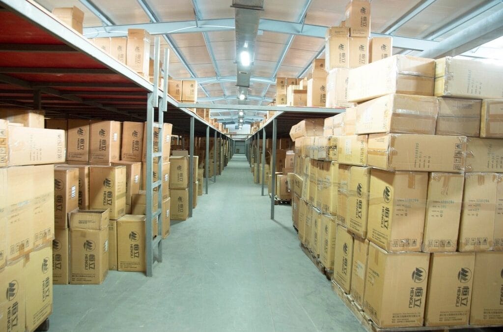 Warehouse aisle of boxed stock managed by an AI agent for inventory management and stock alerts